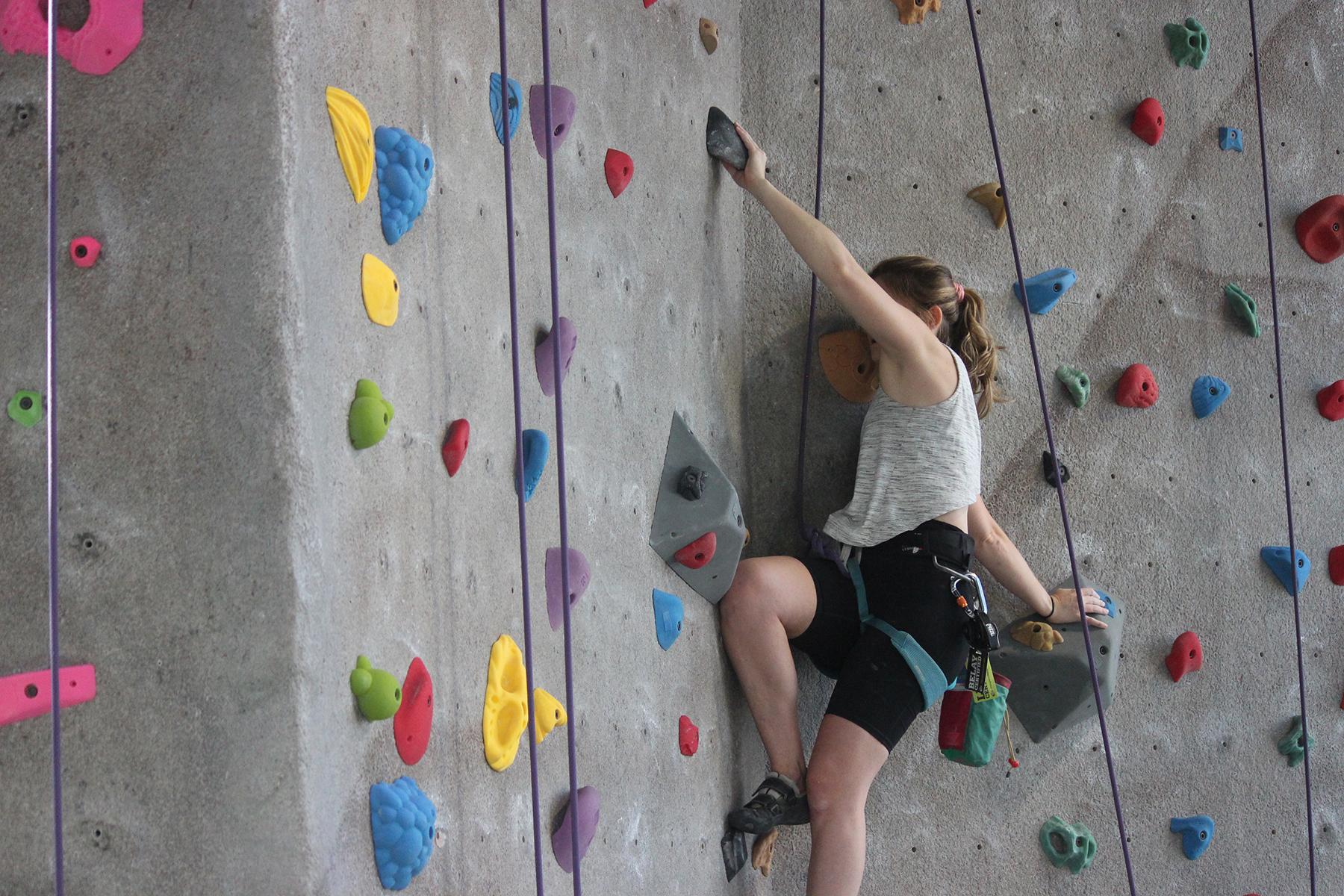 Girl climbing at the Wilson Climbing Wall